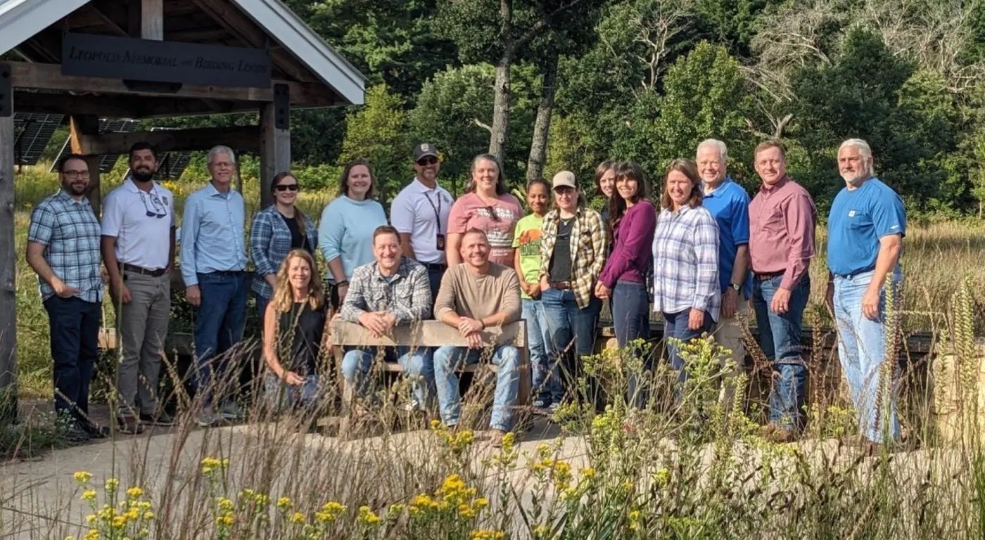 Photos of smiling people behind prairie plants with a picnic shelter in the background