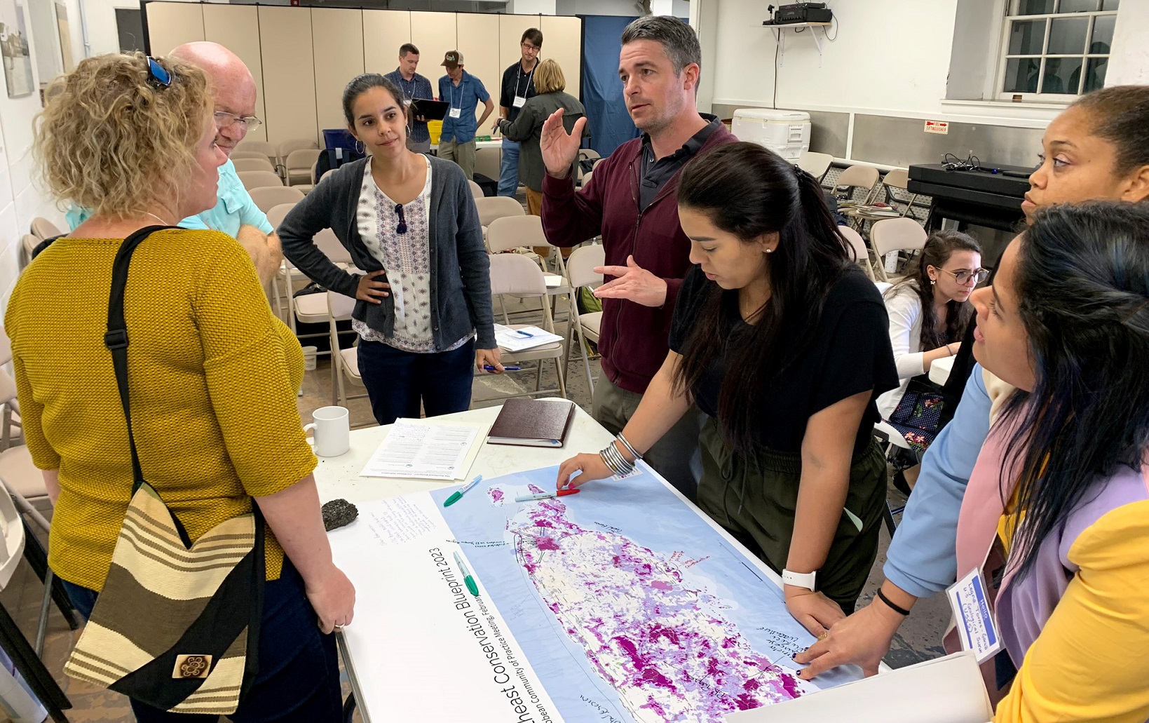 A group of conservation professionals investigating a map.